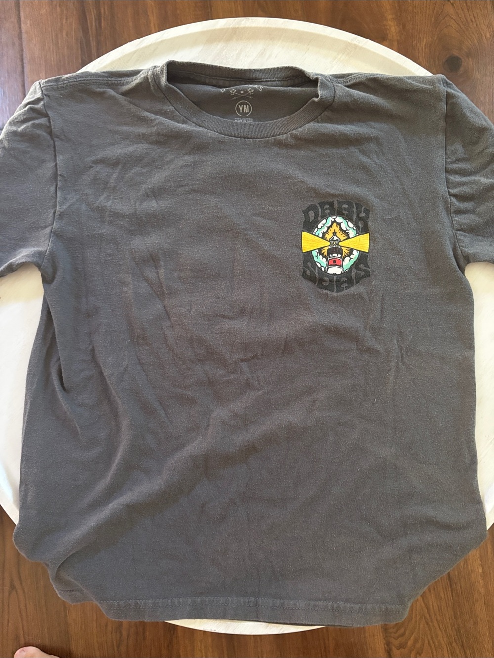 Vintage-Style Black Graphic Tee with Small Chest Logo
